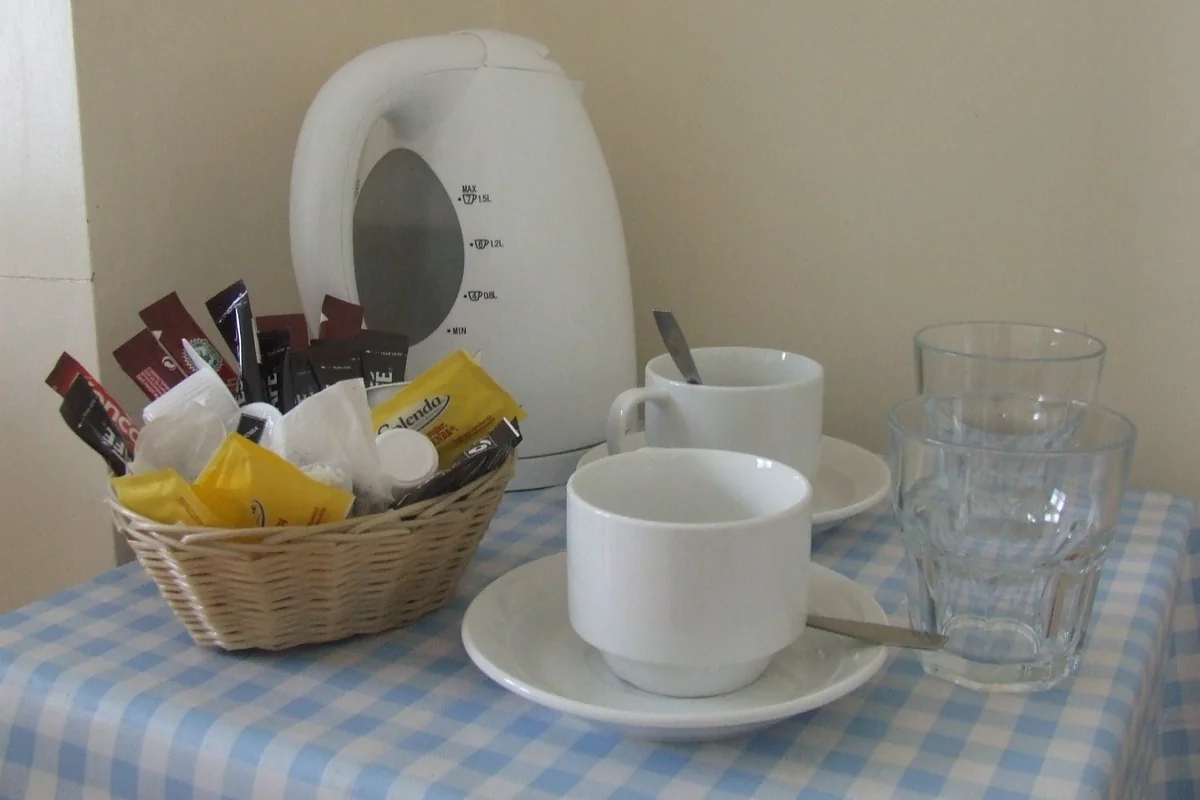 Complimentary tea and coffee facilities with kettle, cups and refreshments at Cedars House