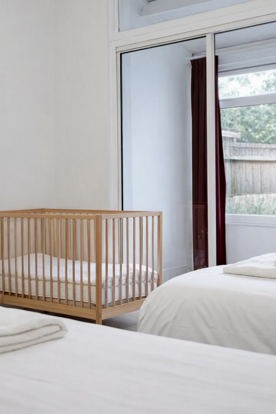 Family Room at Cedars House with baby cot beside a window