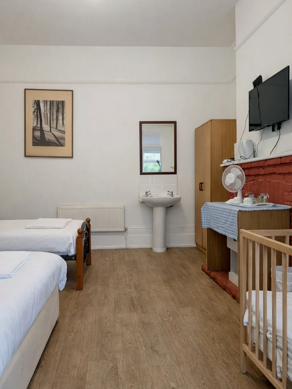 Family Room at Cedars House with sleeping area and private washbasin